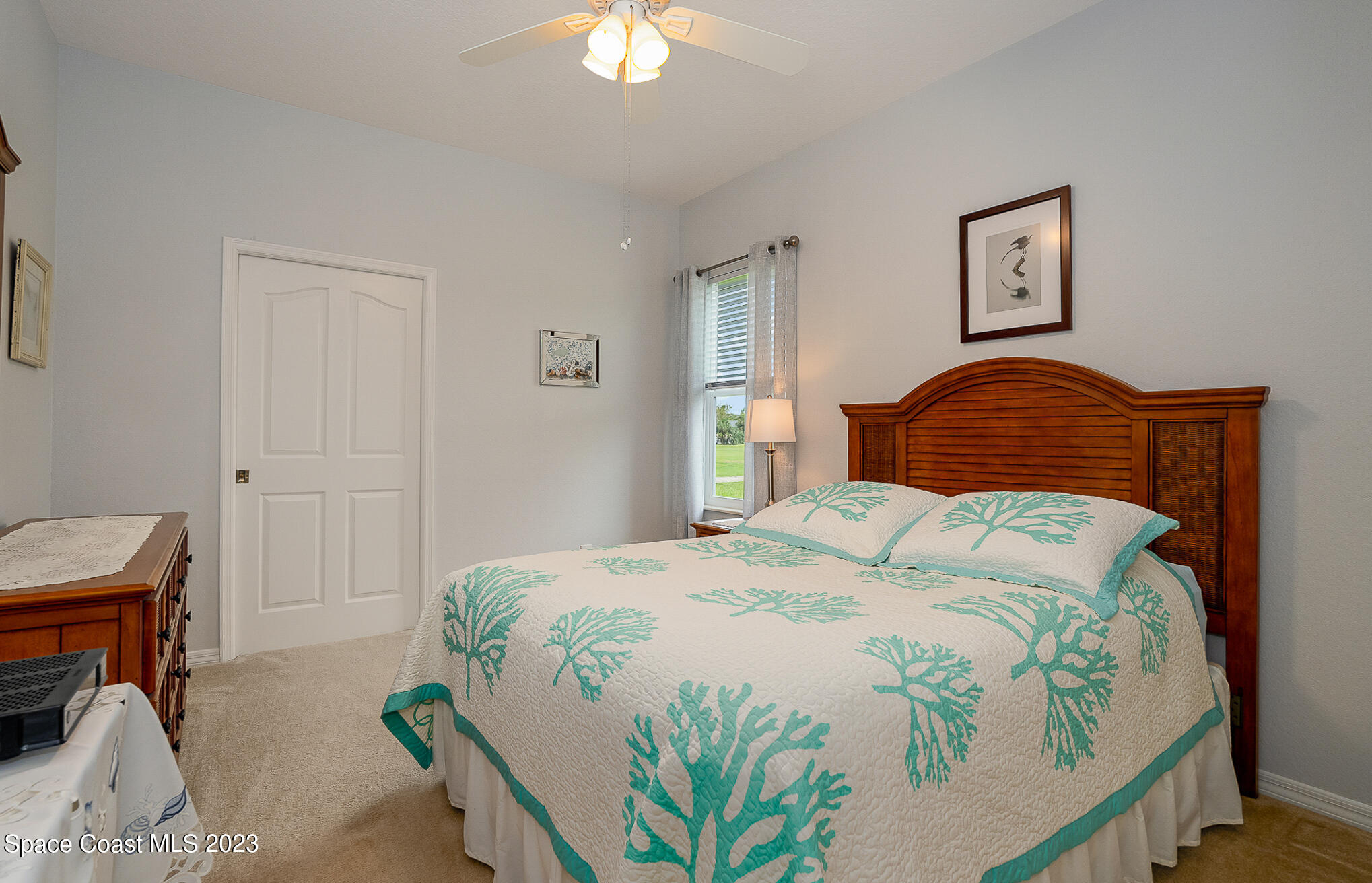 4105 Sand Ridge Drive Merritt Island, FL 32953 - Photo 20 of 31 a bedroom with a bed and a chandelier