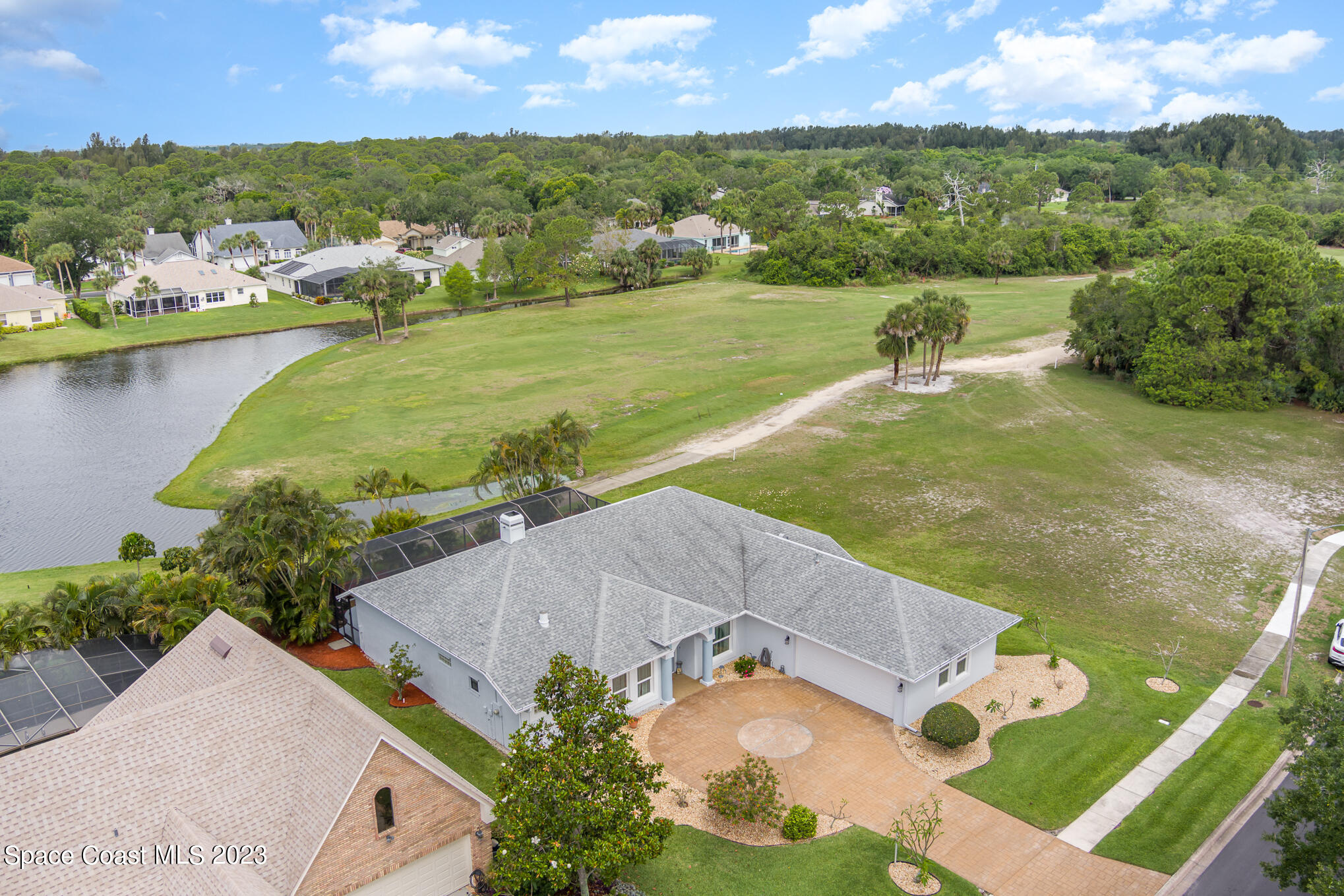 4105 Sand Ridge Drive Merritt Island, FL 32953 - Photo 2 of 31 an aerial view of residential houses with outdoor space and lake view