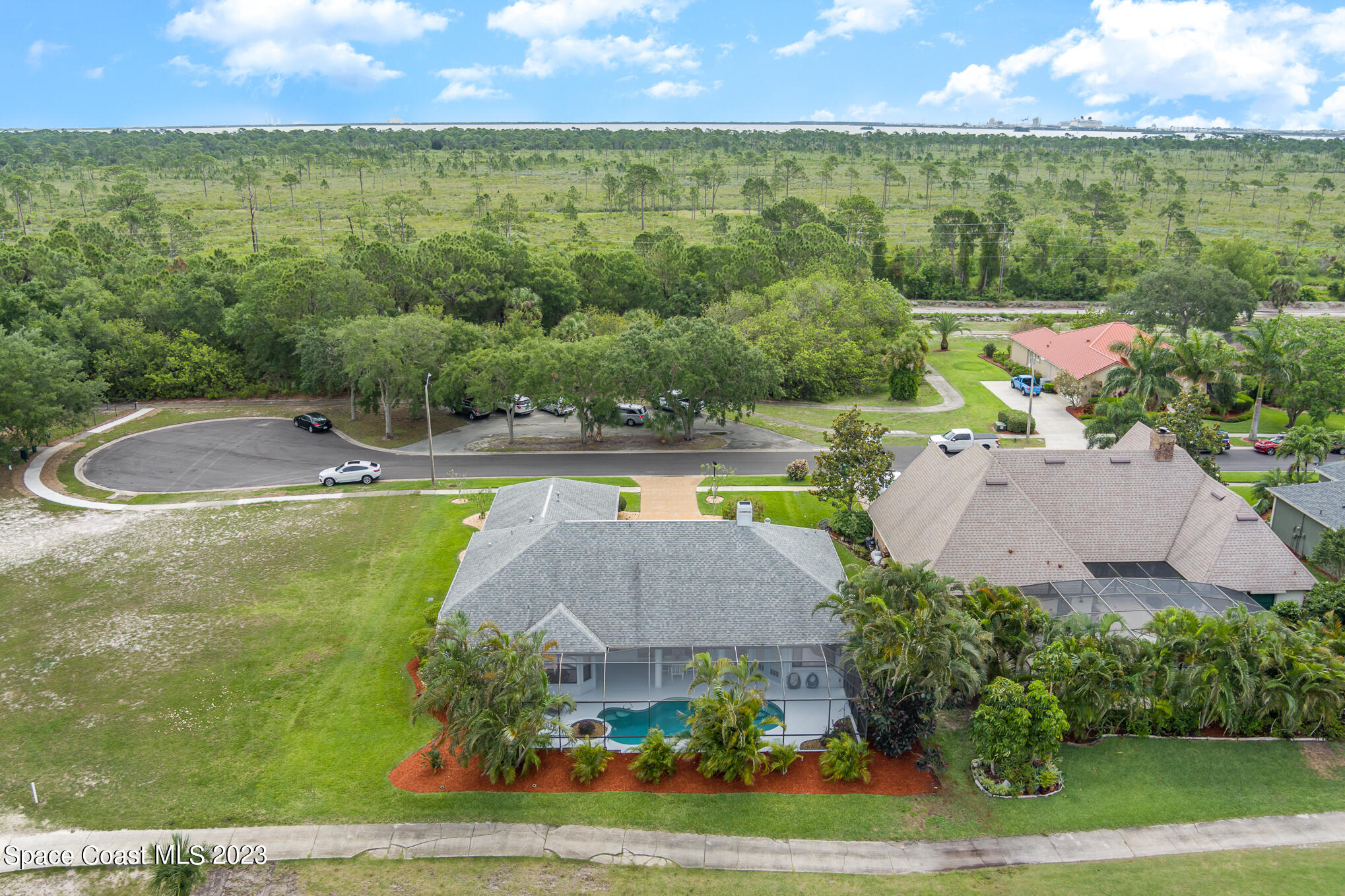 4105 Sand Ridge Drive Merritt Island, FL 32953 - Photo 27 of 31 an aerial view of a house with a garden and lake view