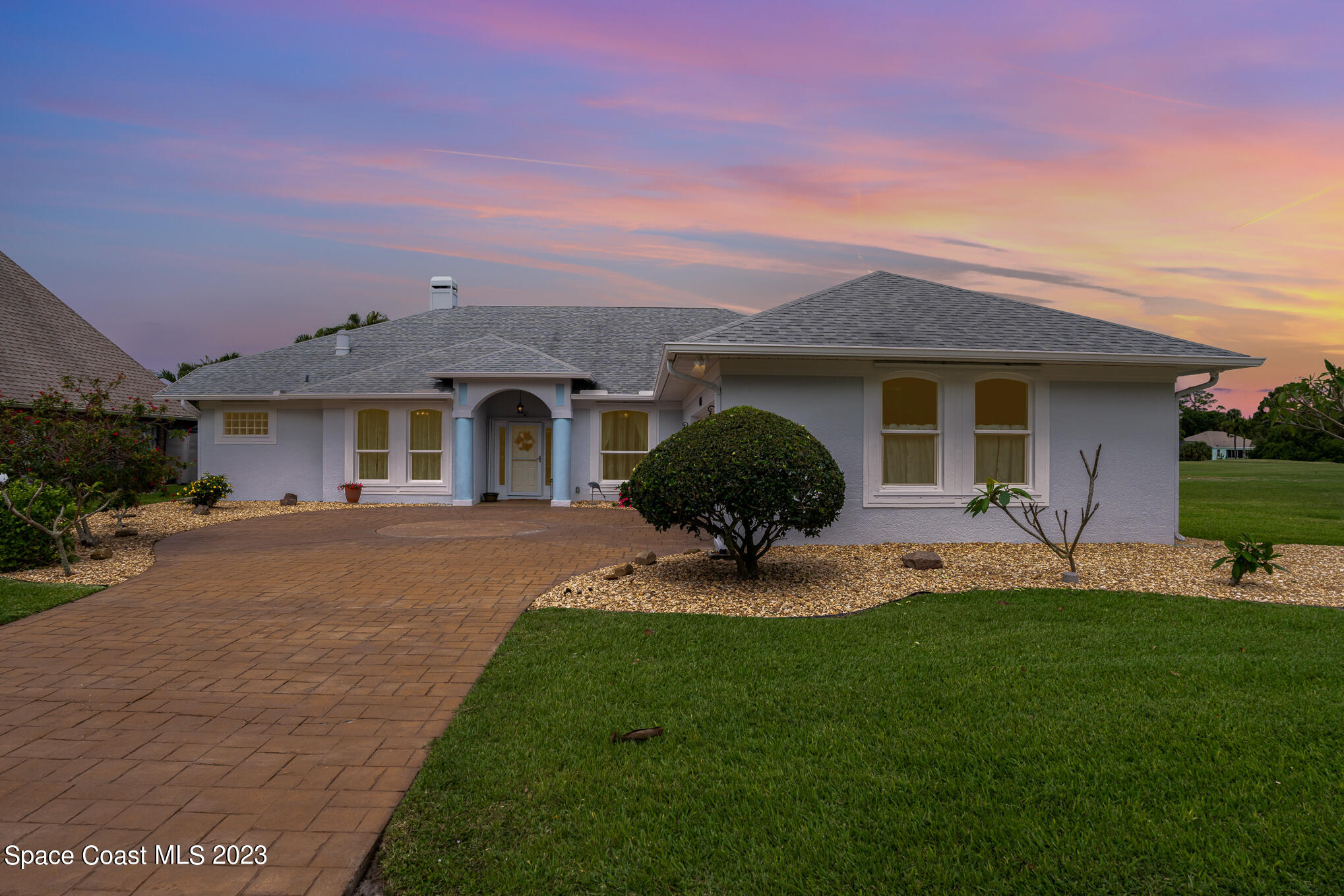 4105 Sand Ridge Drive Merritt Island, FL 32953 - Photo 30 of 31 a front view of a house with a garden and yard