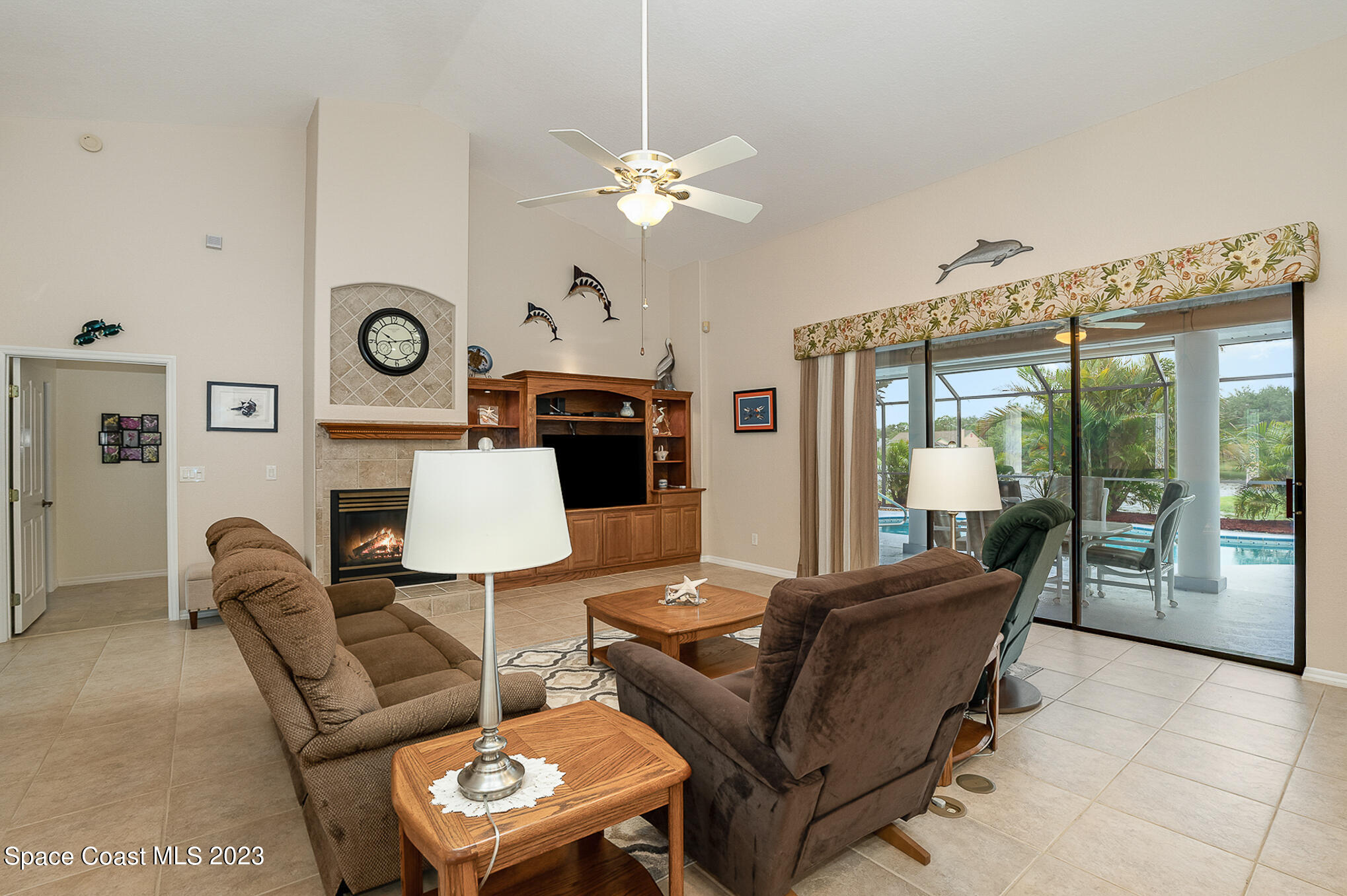 4105 Sand Ridge Drive Merritt Island, FL 32953 - Photo 5 of 31 a living room with furniture a clock and a large window