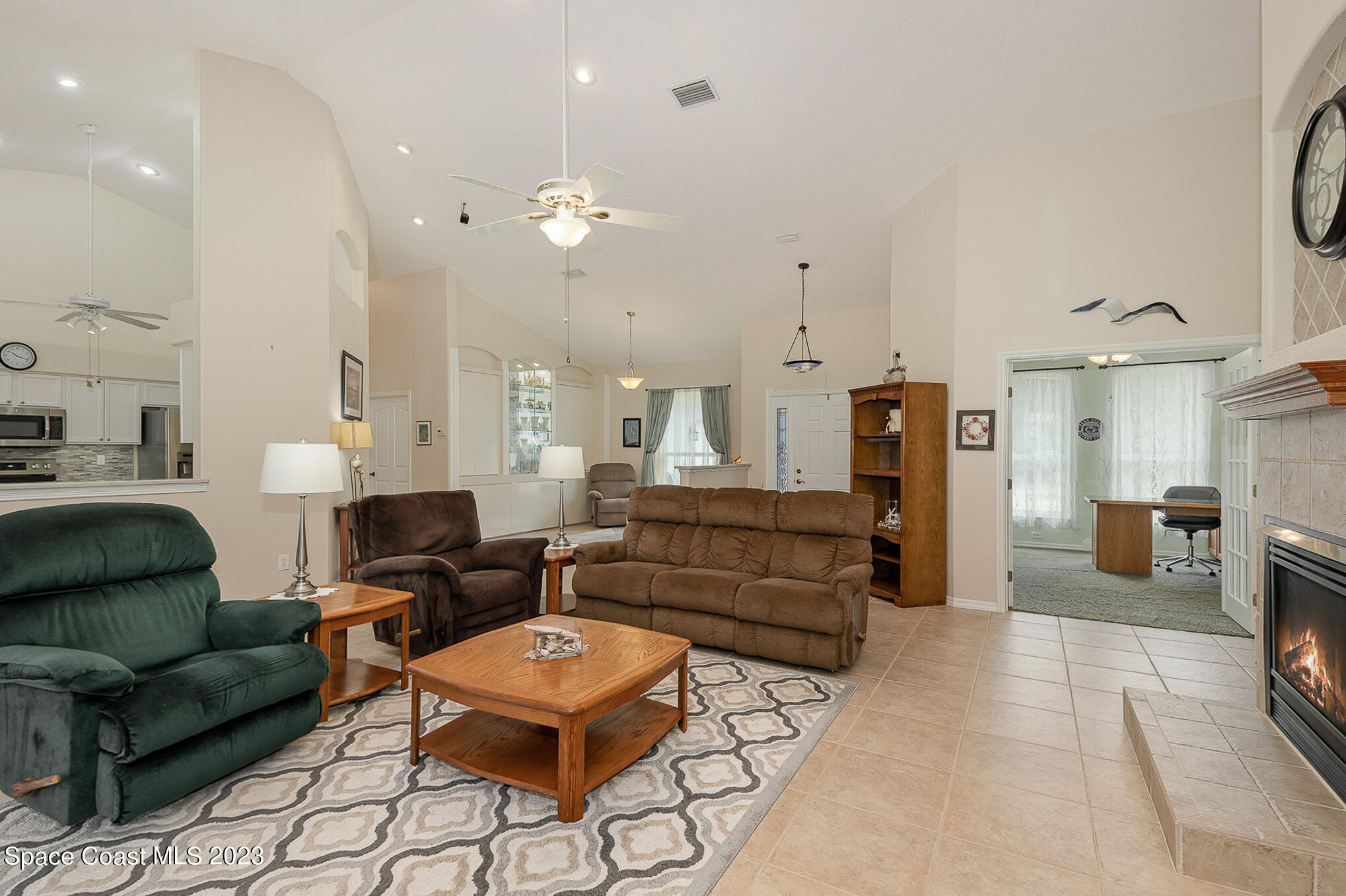4105 Sand Ridge Drive Merritt Island, FL 32953 - Photo 6 of 31 a living room with furniture kitchen view and a chandelier