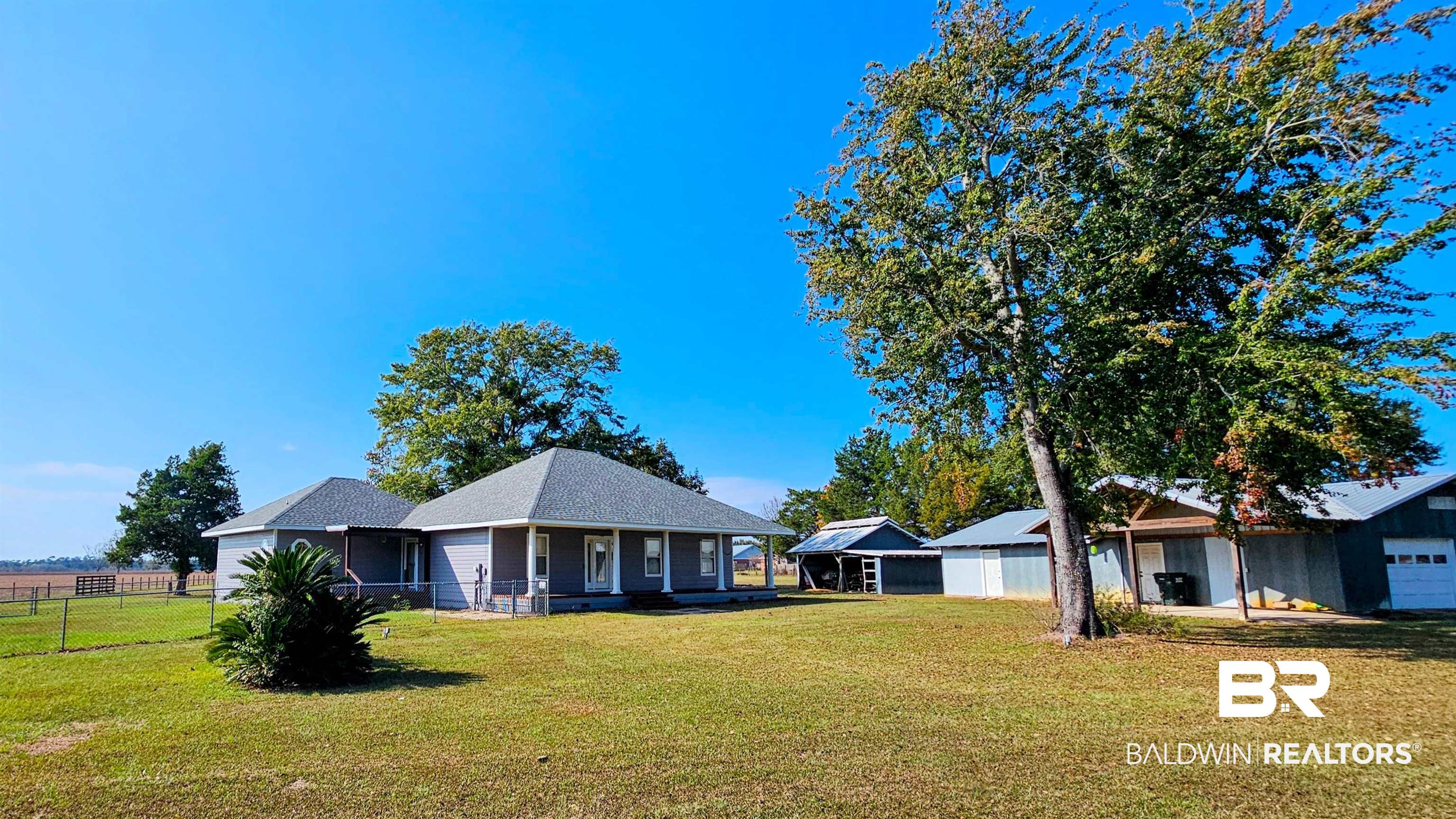 9275 Crawford Road Elberta, AL 36530 - Photo 2 of 28 View of front facade featuring a shingled roof and covered porch