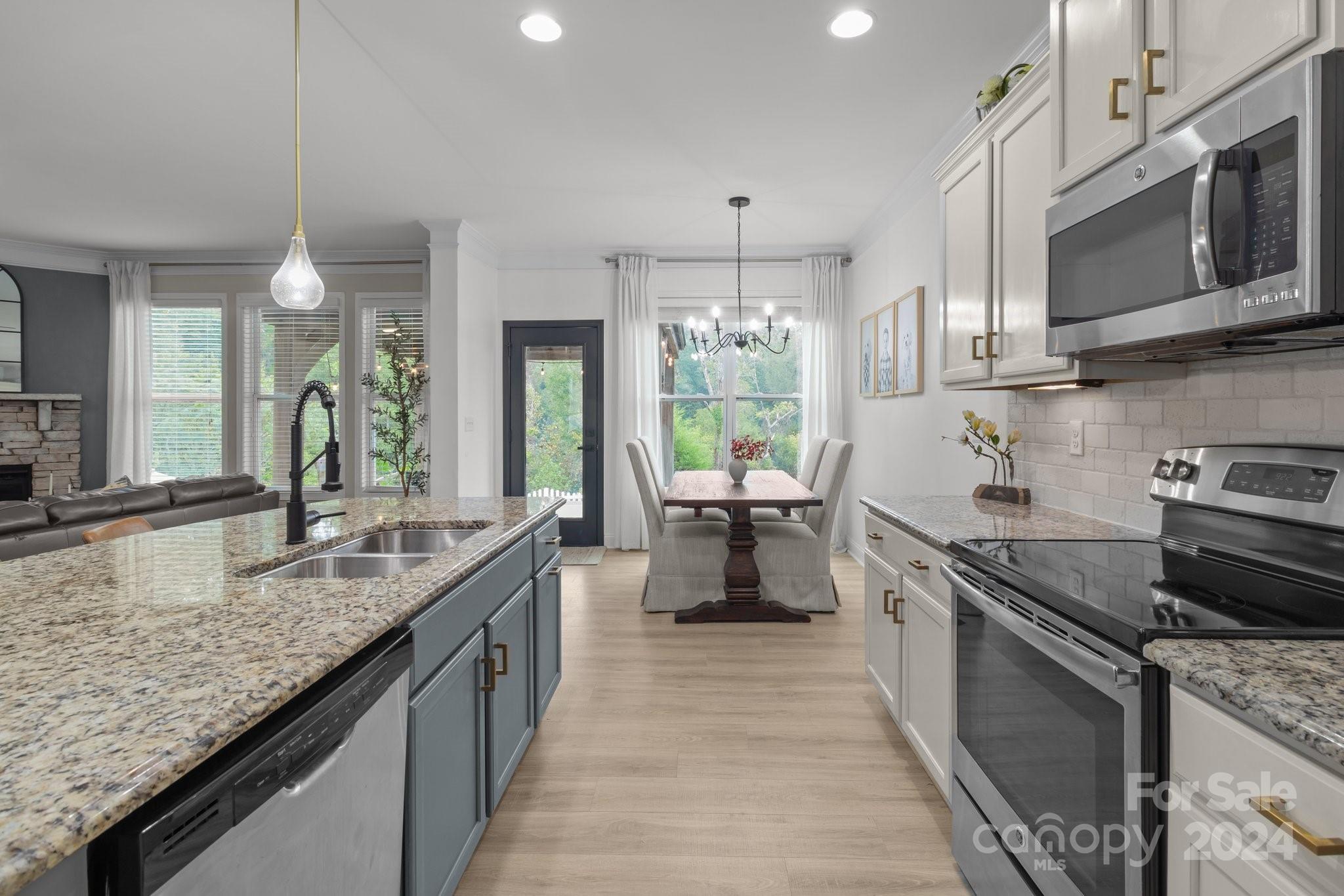 3434 Streamside Drive Davidson, NC 28036 - Photo 8 of 34 a kitchen with stainless steel appliances granite countertop a sink stove and cabinets