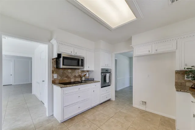 a kitchen with a refrigerator and a sink