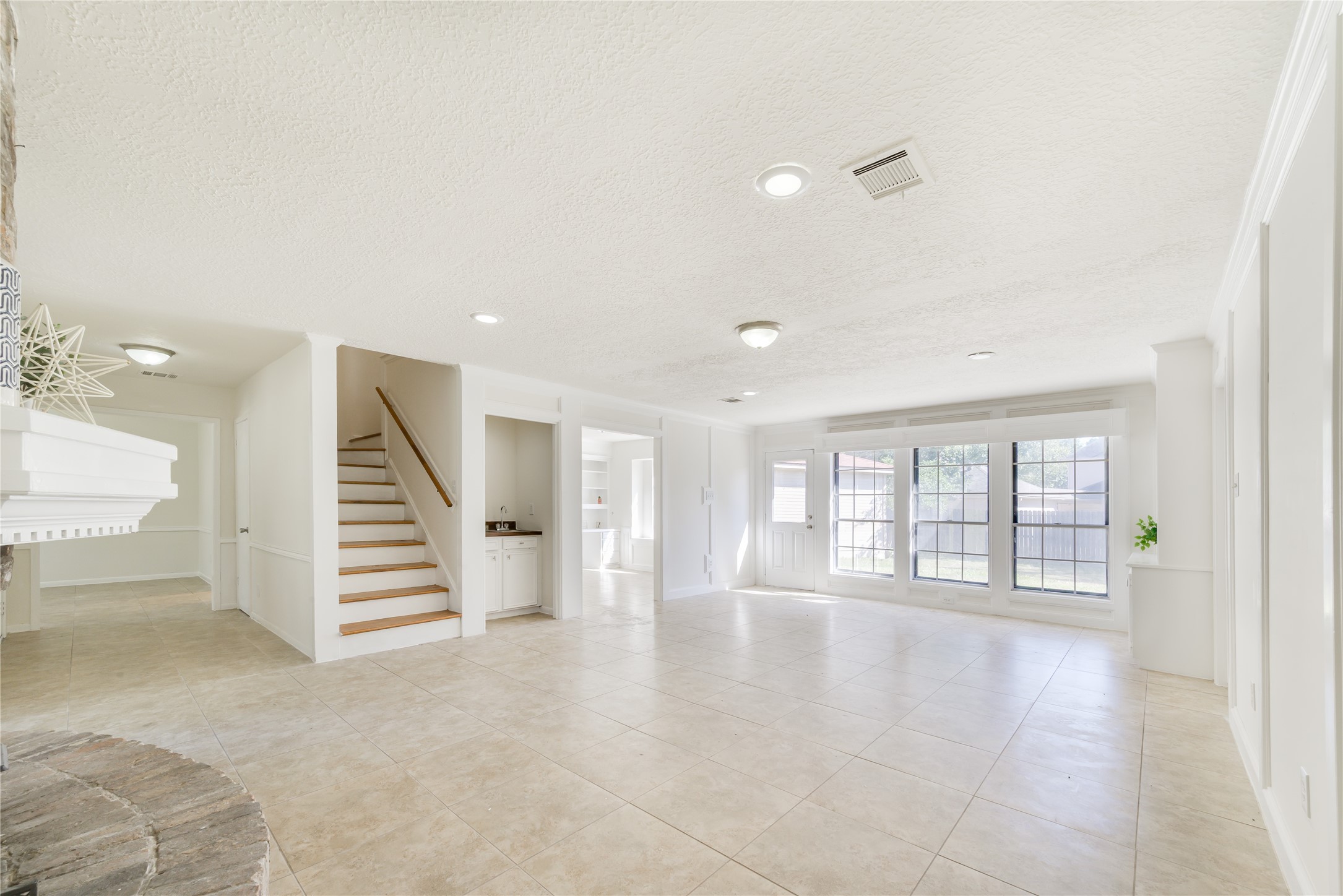 18318 Ella Boulevard Spring, TX 77388 - Photo 16 of 50 a view of an empty room with stairs and a living room