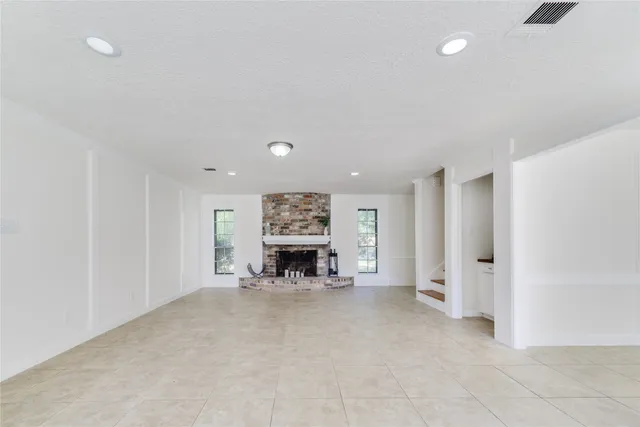 an empty room with furniture and fireplace