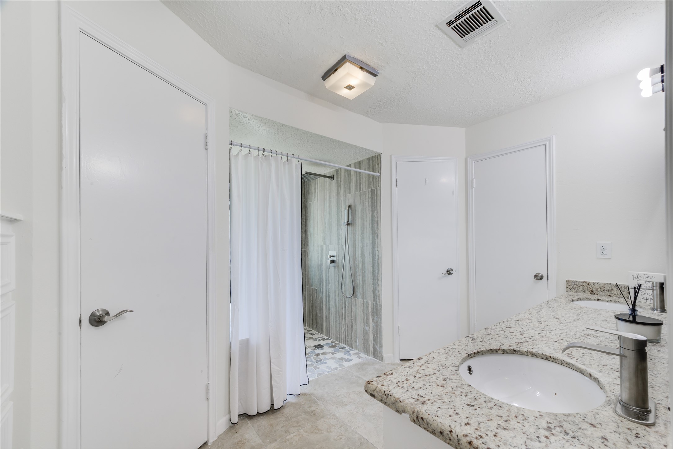 18318 Ella Boulevard Spring, TX 77388 - Photo 32 of 50 a bathroom with a granite countertop sink and a mirror