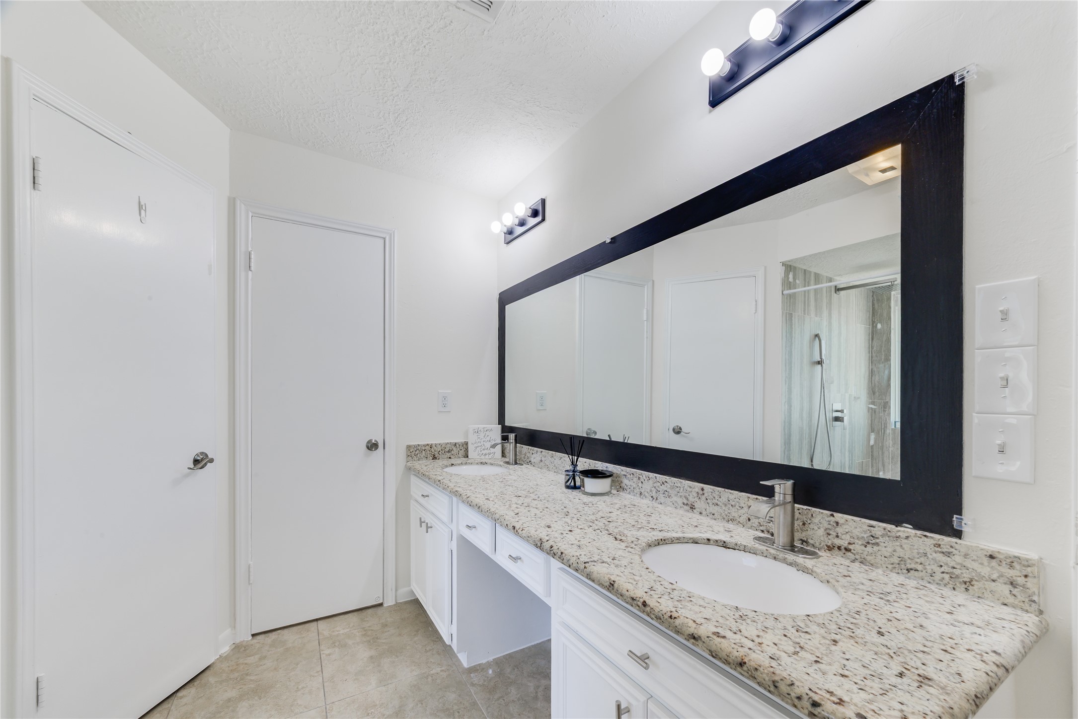 18318 Ella Boulevard Spring, TX 77388 - Photo 33 of 50 a bathroom with a granite countertop sink and a mirror