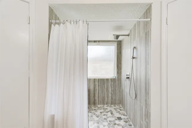 a bathroom with a shower and a sink