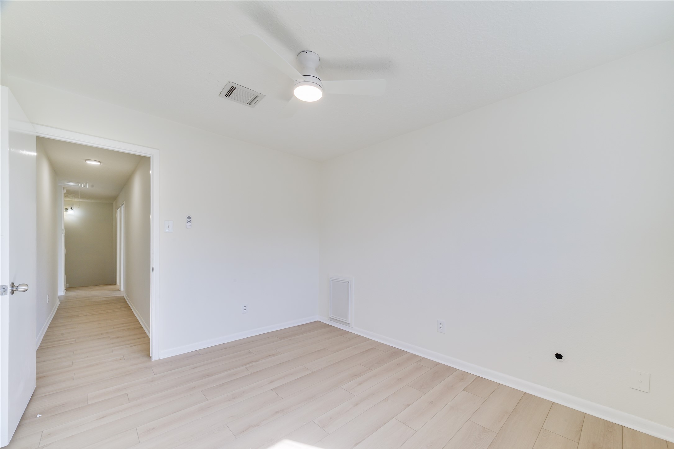 18318 Ella Boulevard Spring, TX 77388 - Photo 36 of 50 an empty room with wooden floor and mirror