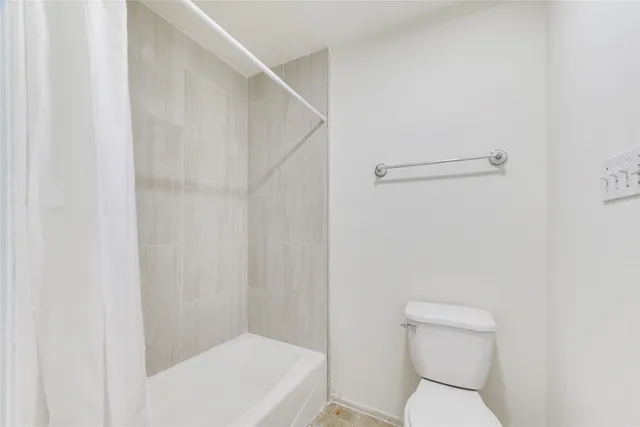 a white toilet sitting next to a white sink