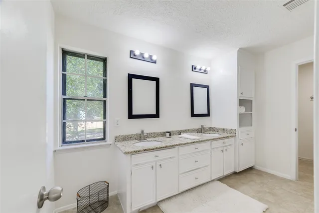 a bathroom with 2 sink tub and a mirror