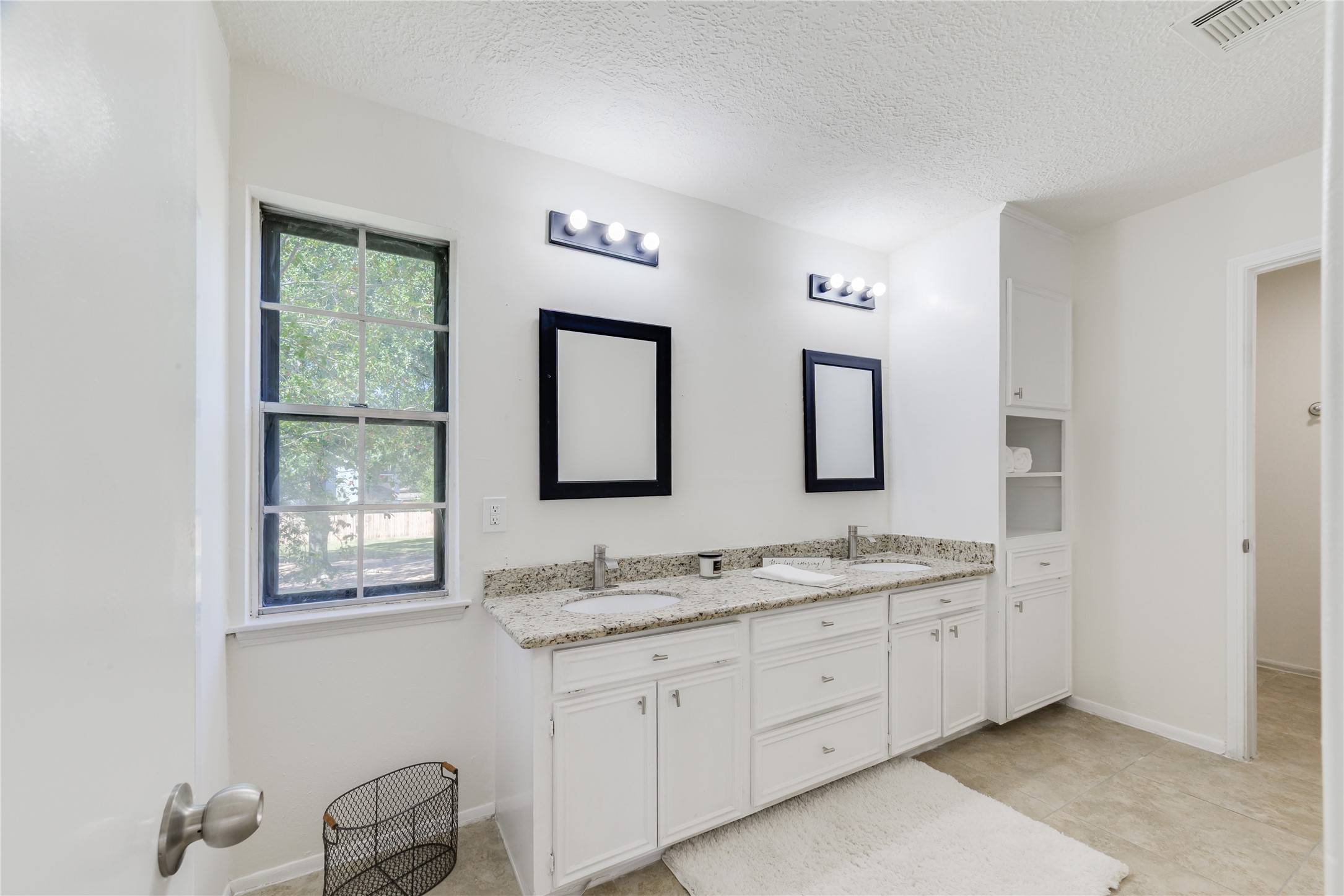 18318 Ella Boulevard Spring, TX 77388 - Photo 44 of 50 a bathroom with 2 sink tub and a mirror