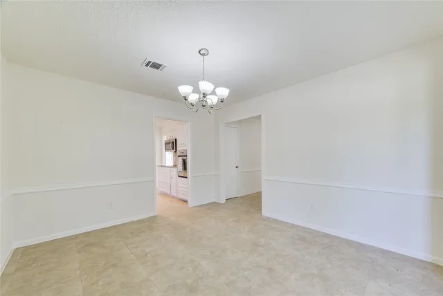 a view of a chandelier in big room and chandelier