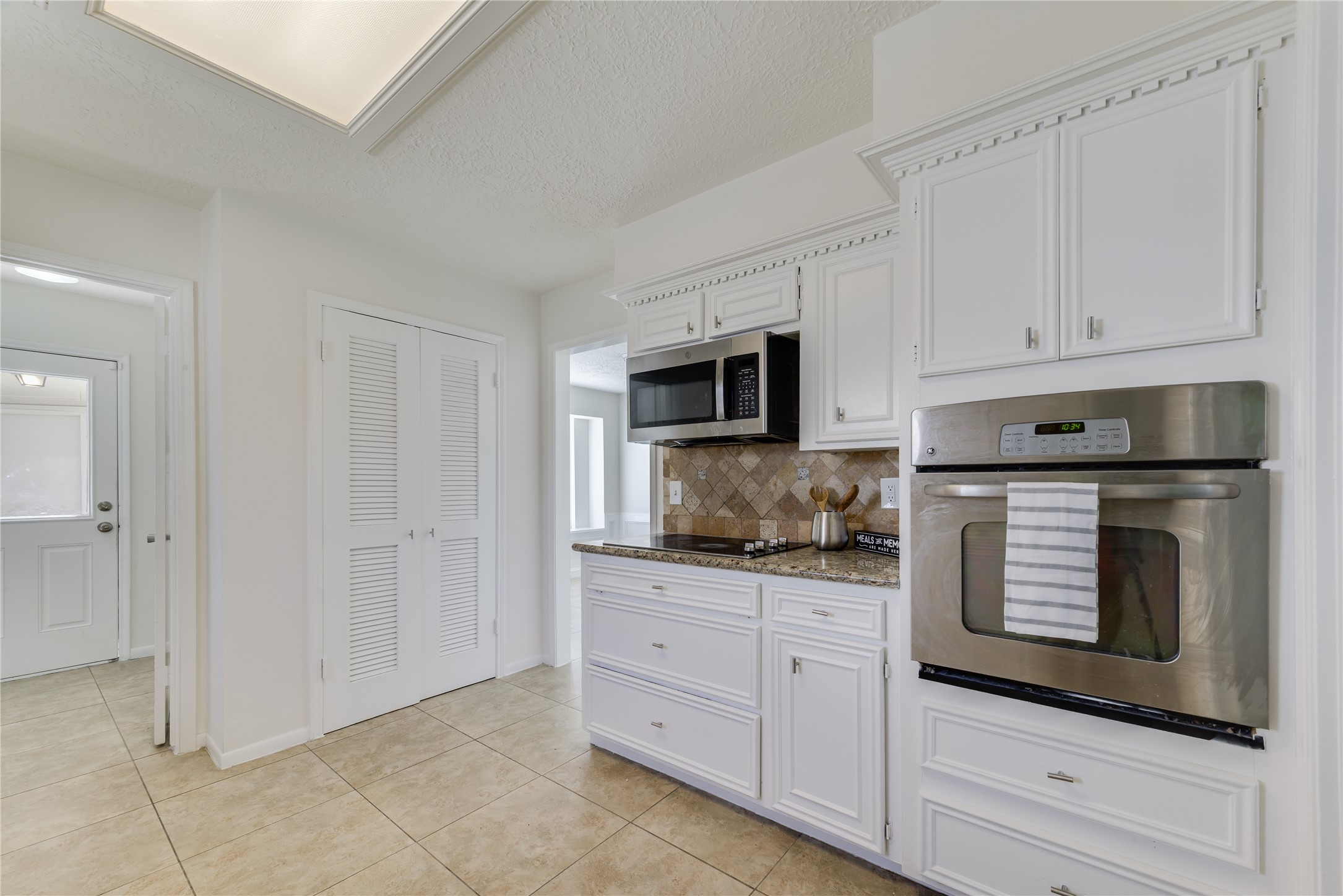 18318 Ella Boulevard Spring, TX 77388 - Photo 9 of 50 a kitchen with white cabinets and appliances