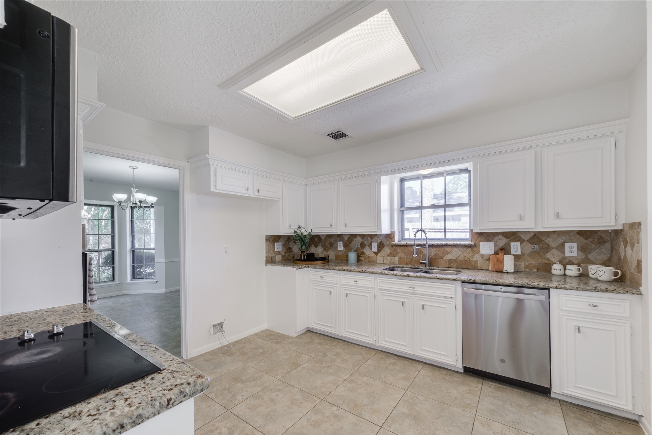 18318 Ella Boulevard Spring, TX 77388 - Photo 10 of 50 a kitchen with a sink stove and cabinets