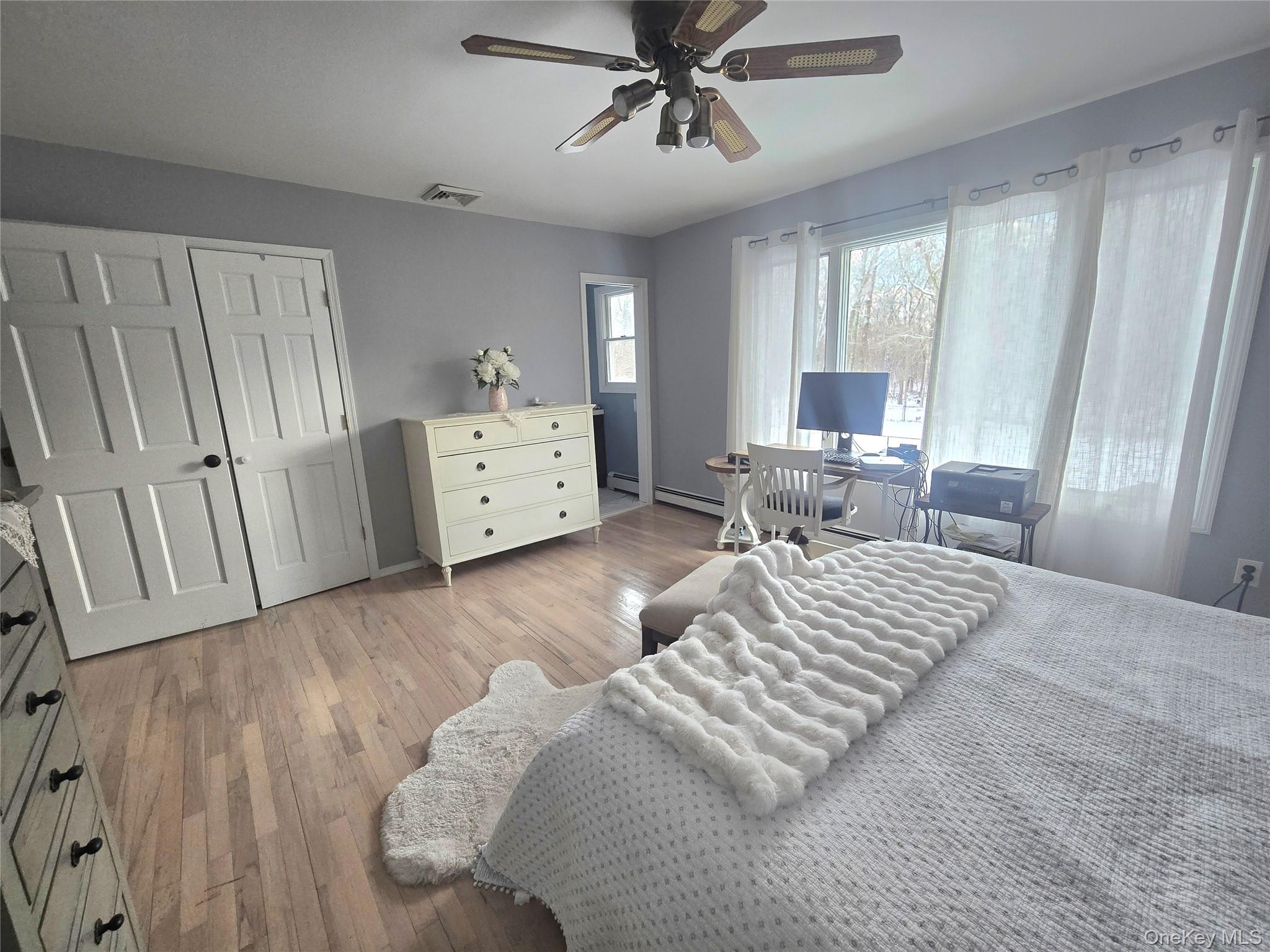 22 Rustic Road Yaphank, NY 11980 - Photo 16 of 35 Bedroom featuring light wood-type flooring, a ceiling fan,