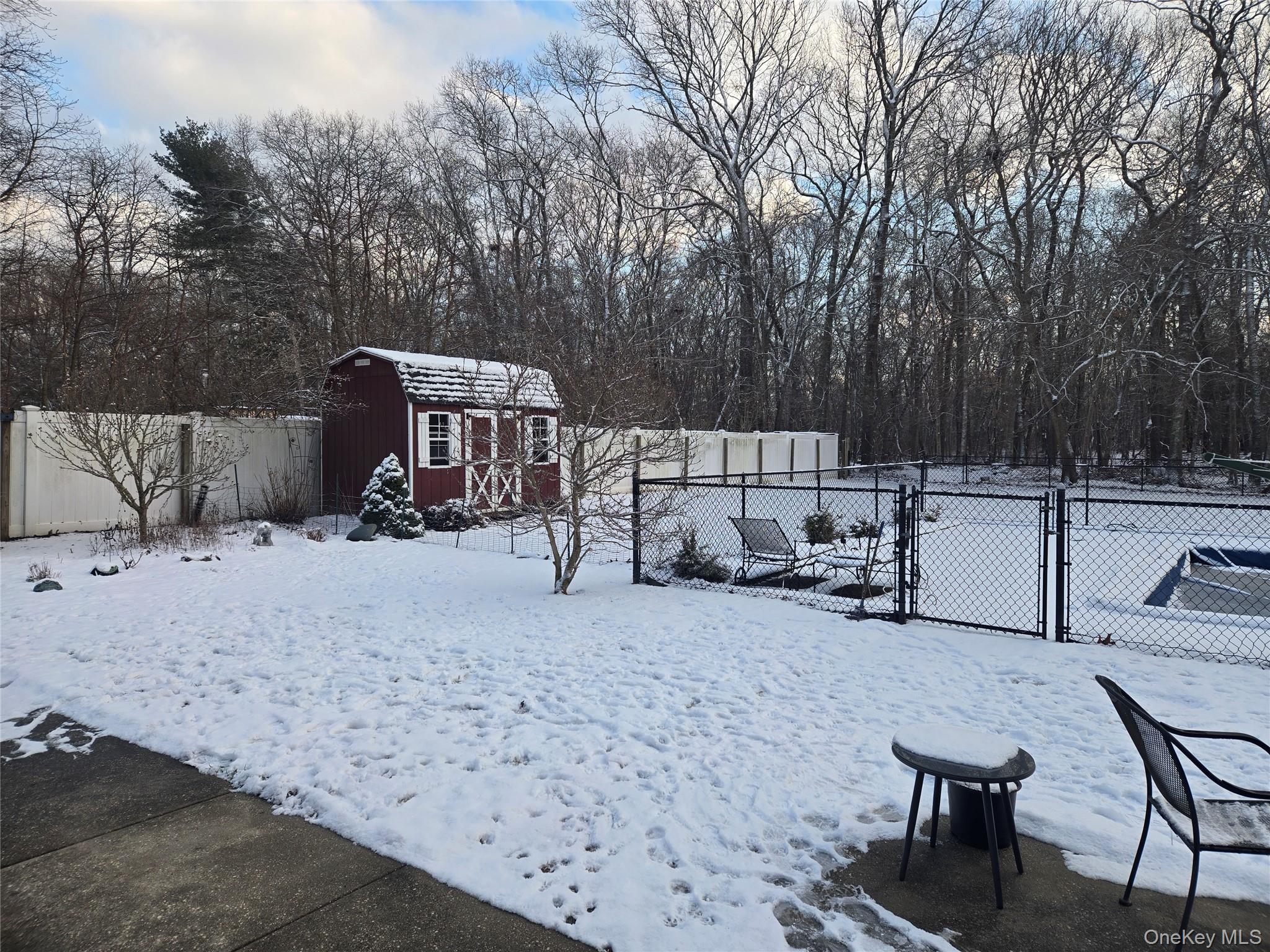 22 Rustic Road Yaphank, NY 11980 - Photo 26 of 35 fenced backyard, a gate, and a shed