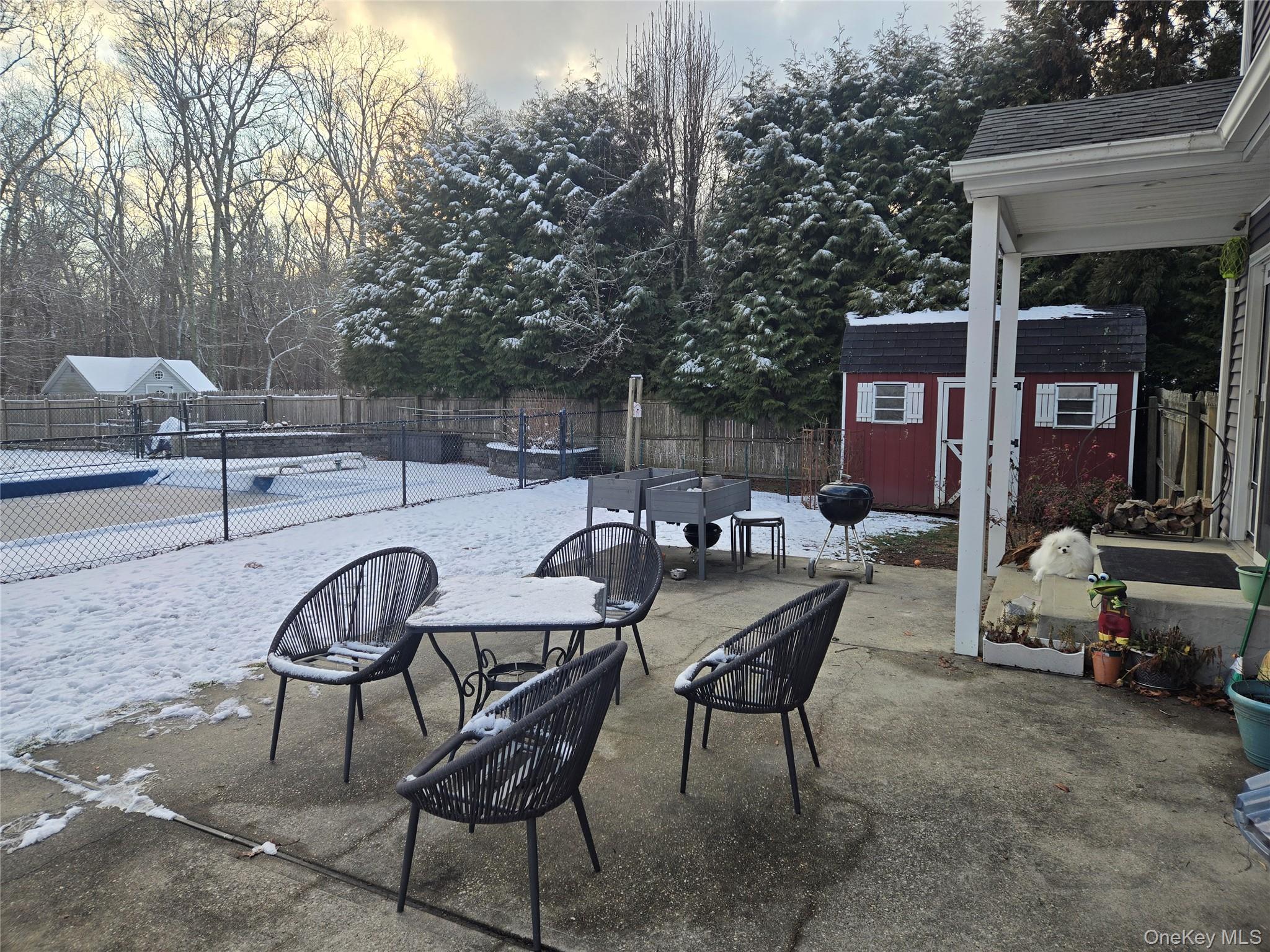 22 Rustic Road Yaphank, NY 11980 - Photo 27 of 35 Fenced backyard featuring a patio area, a storage shed, grilling area, and outdoor dining area