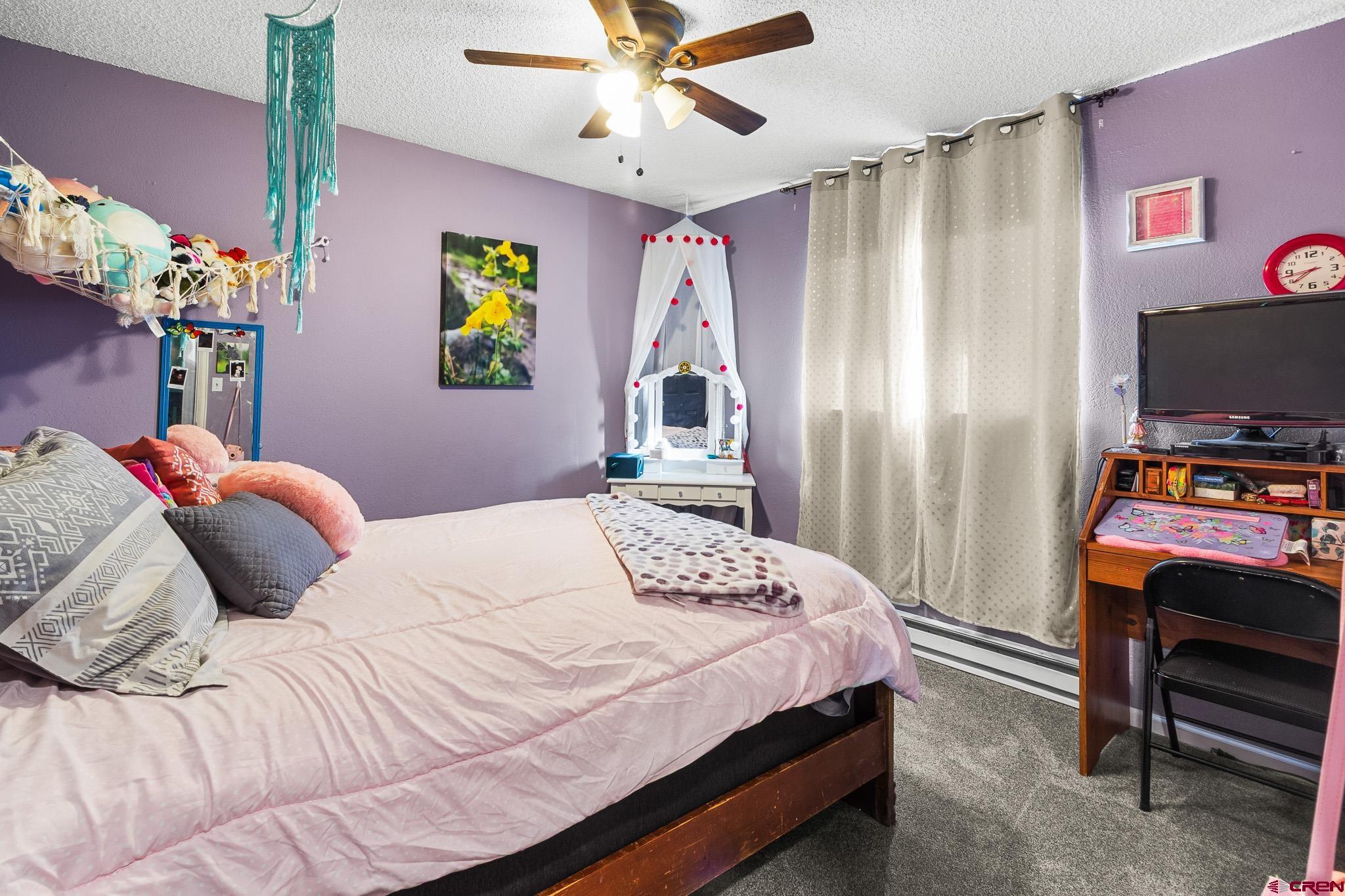 13330 L Road Montrose, CO 81401 - Photo 15 of 19 a bedroom with a bed and a flat screen tv