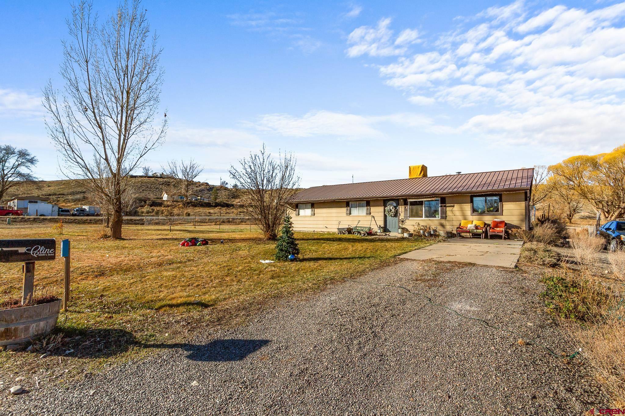 13330 L Road Montrose, CO 81401 - Photo 2 of 19 a view of swimming pool with lawn chairs and wooden fence