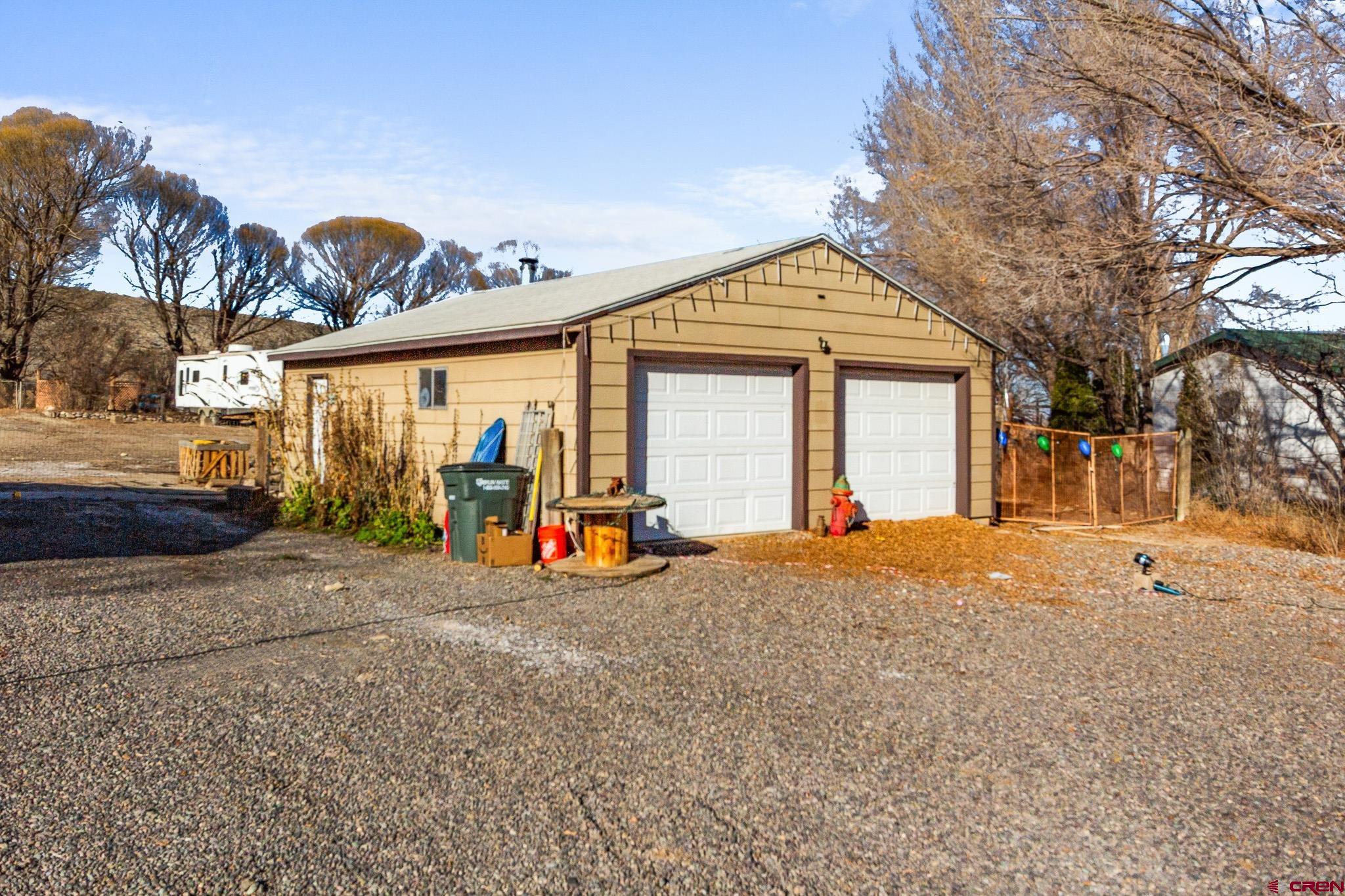 13330 L Road Montrose, CO 81401 - Photo 5 of 19 a view of a house with a yard and garage