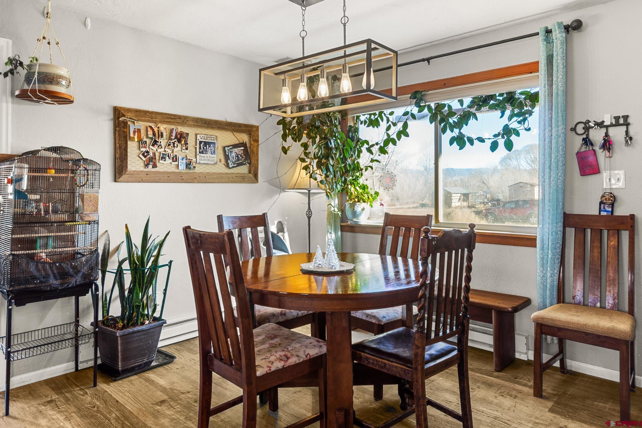 13330 L Road Montrose, CO 81401 - Photo 7 of 19 a dining room with furniture a large window and a chandelier