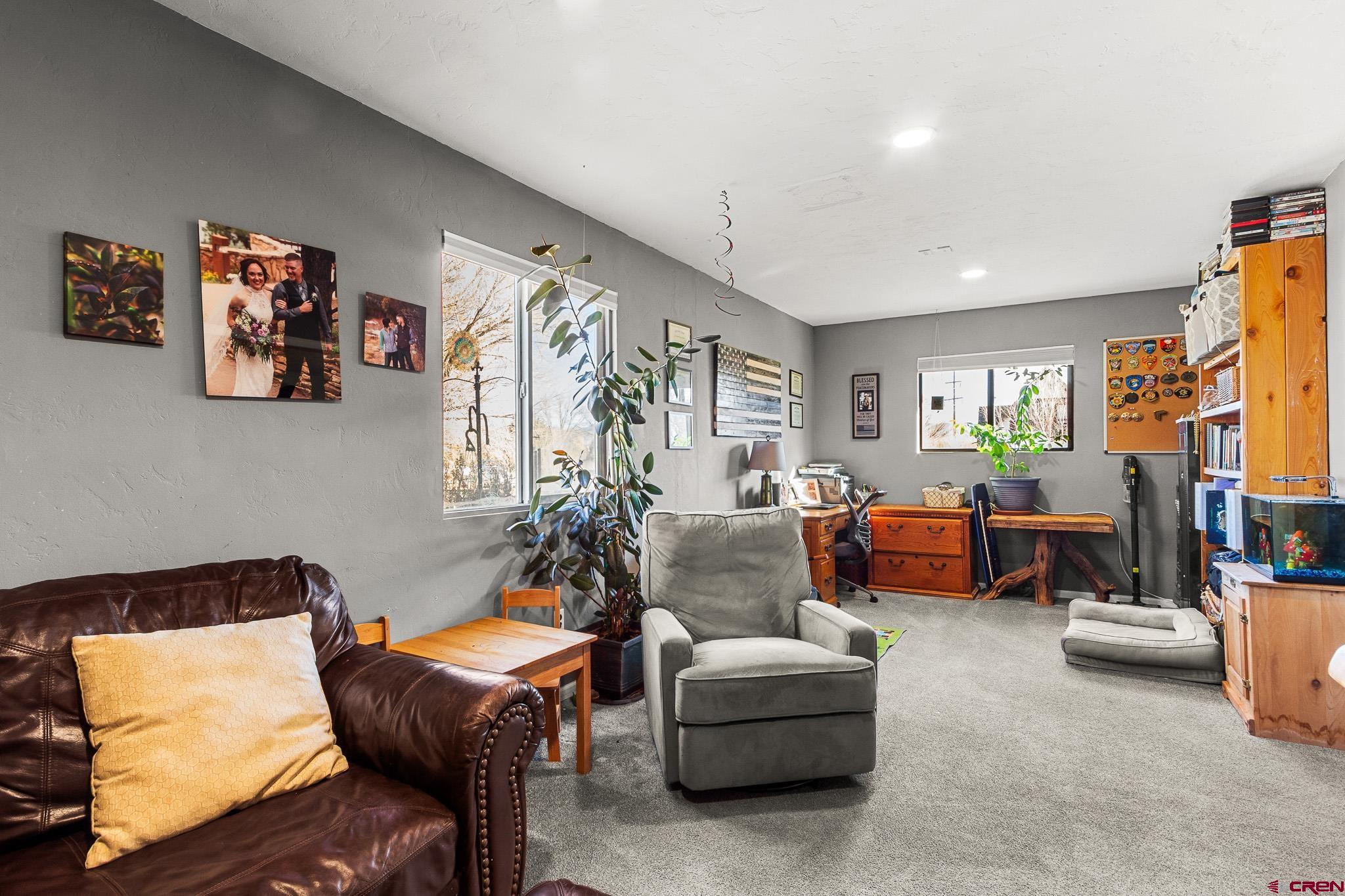 13330 L Road Montrose, CO 81401 - Photo 9 of 19 a living room with furniture and a flat screen tv