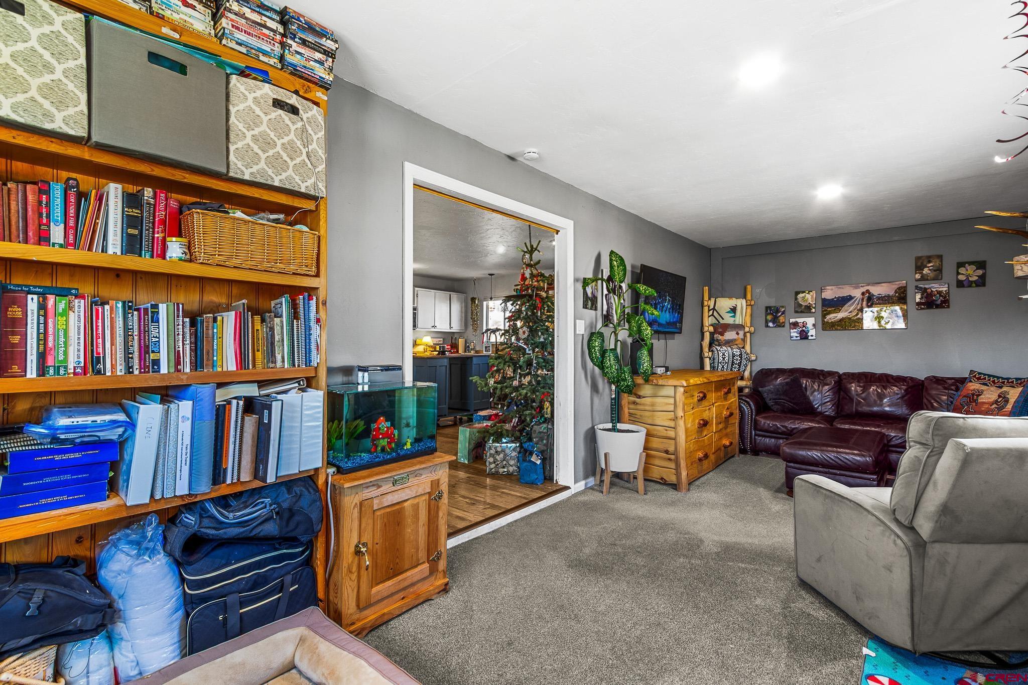 13330 L Road Montrose, CO 81401 - Photo 10 of 19 a living room with furniture and a book shelf
