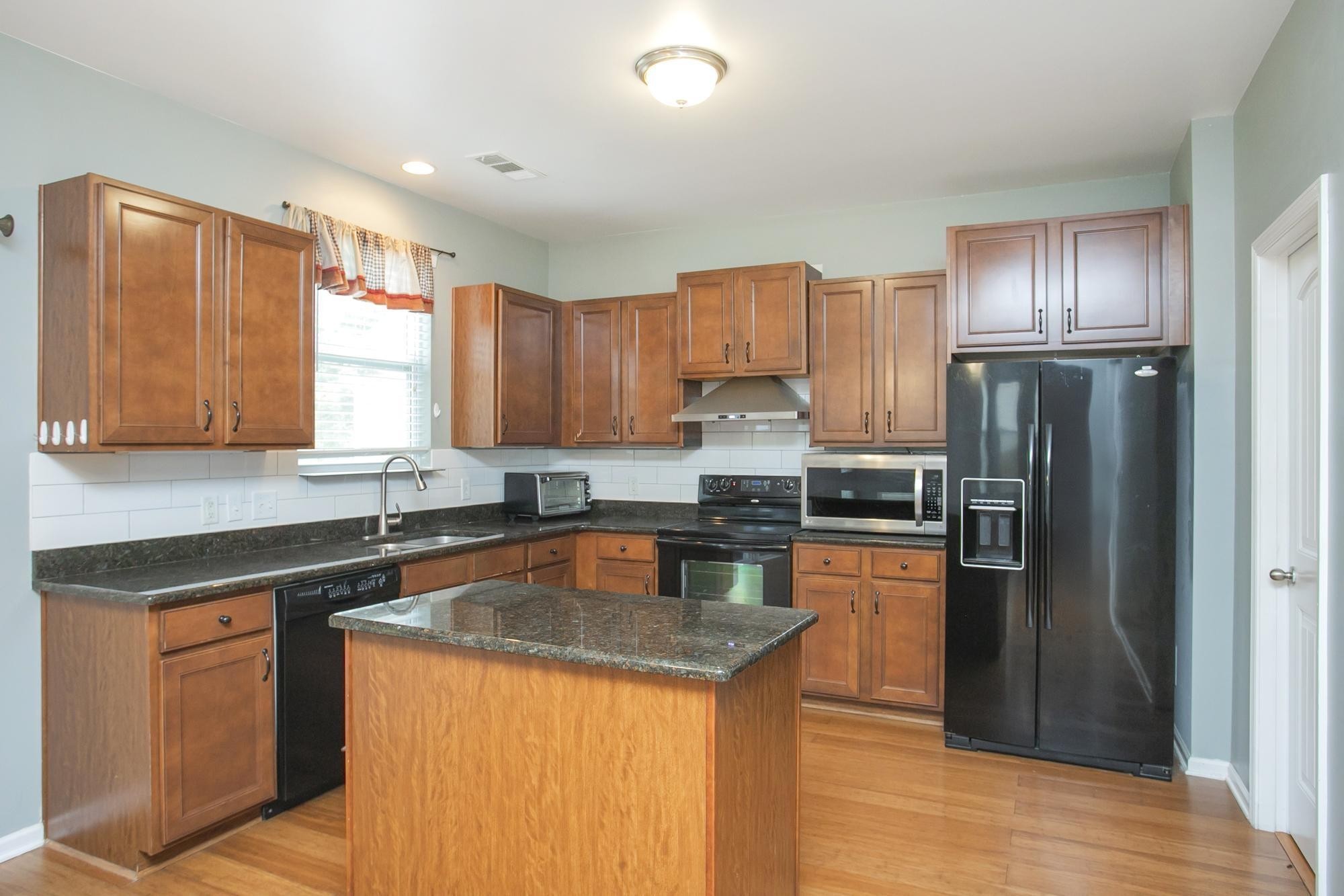 3601 Harpeth Springs Drive Nashville, TN 37221 - Photo 11 of 55 a kitchen with kitchen island granite countertop stainless steel appliances cabinets a sink and a counter space