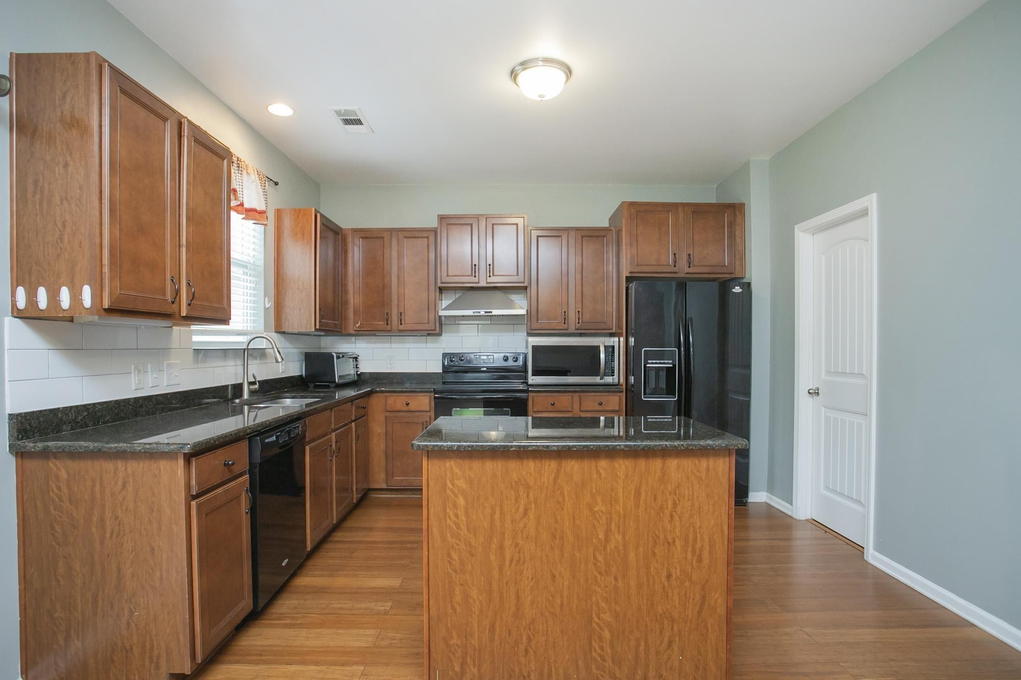3601 Harpeth Springs Drive Nashville, TN 37221 - Photo 12 of 55 a kitchen with stainless steel appliances granite countertop a sink stove and refrigerator