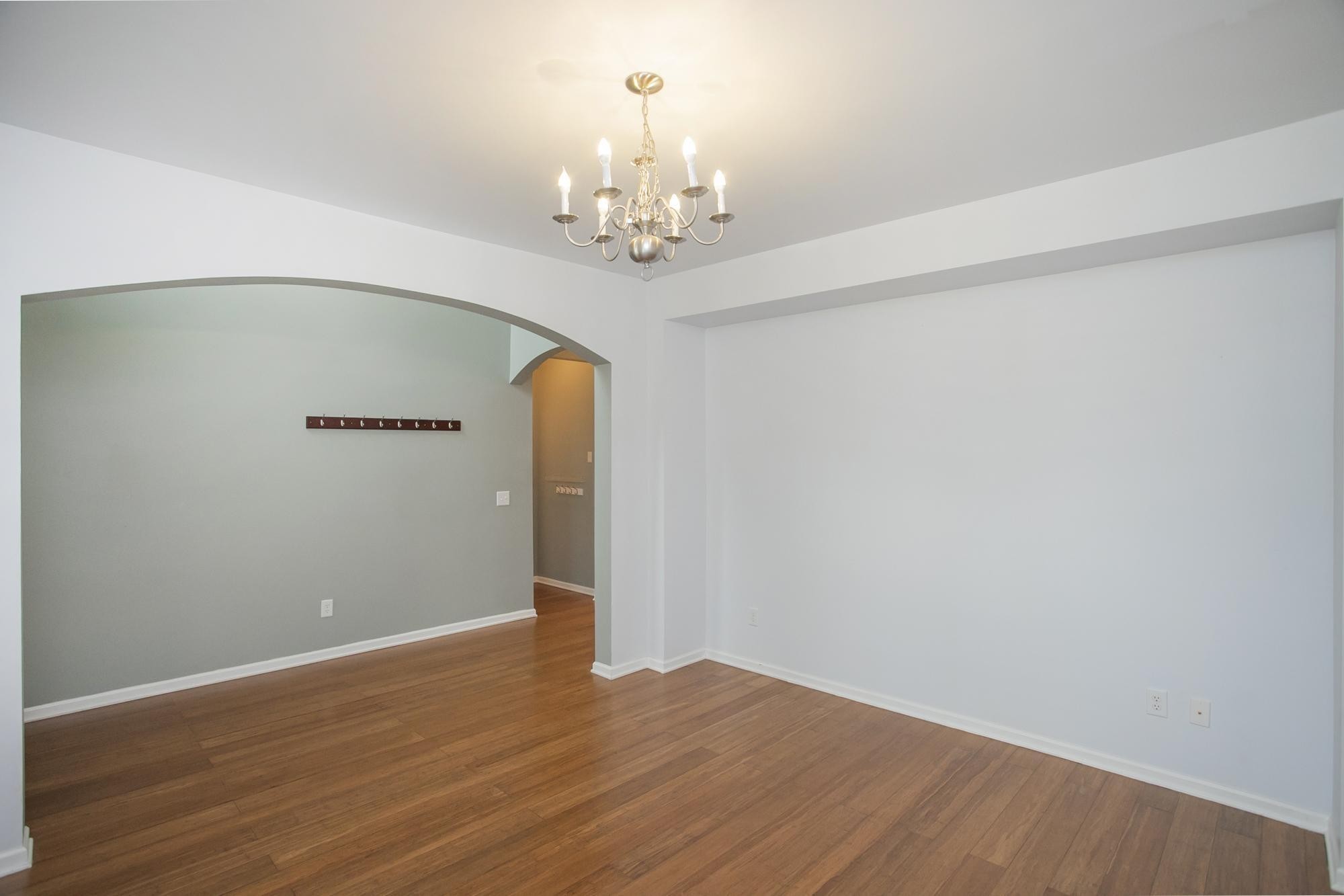 3601 Harpeth Springs Drive Nashville, TN 37221 - Photo 8 of 55 wooden floor in an empty room with a chandelier