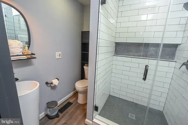 a bathroom with a toilet and a shower