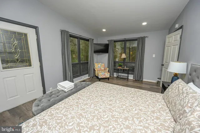 a room with pool table windows and wooden floor