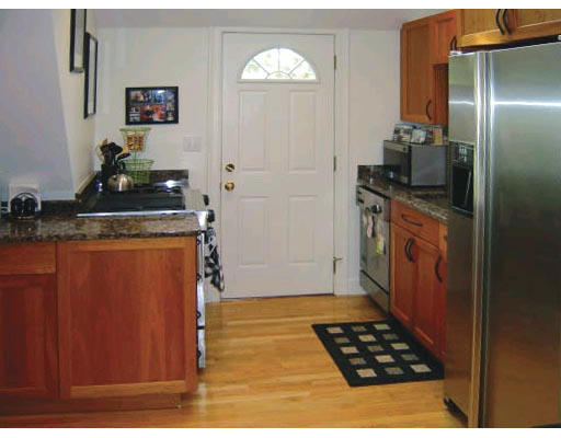111 Sutherland Road, Unit 3A Boston, MA 02135 - Photo 5 of 9 a kitchen with stainless steel appliances granite countertop a refrigerator and a stove