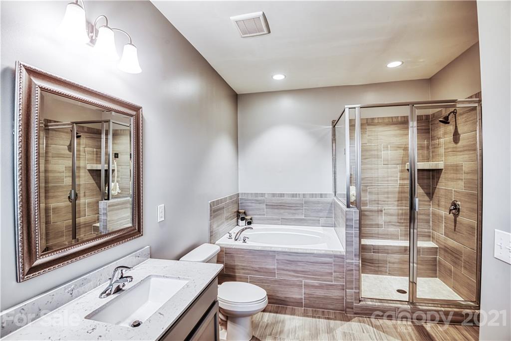 606 Amber Meadows Way Tega Cay, SC 29708 - Photo 14 of 23 a bathroom with a bathtub shower sink mirror and toilet