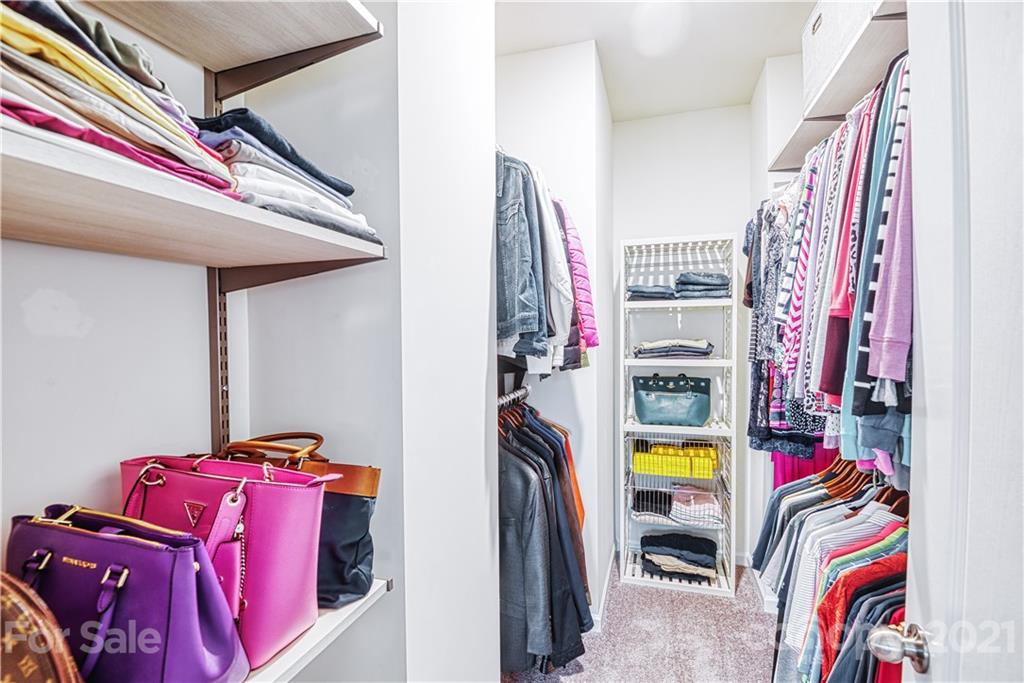 606 Amber Meadows Way Tega Cay, SC 29708 - Photo 15 of 23 a view of walk in closet with clothes and shoes