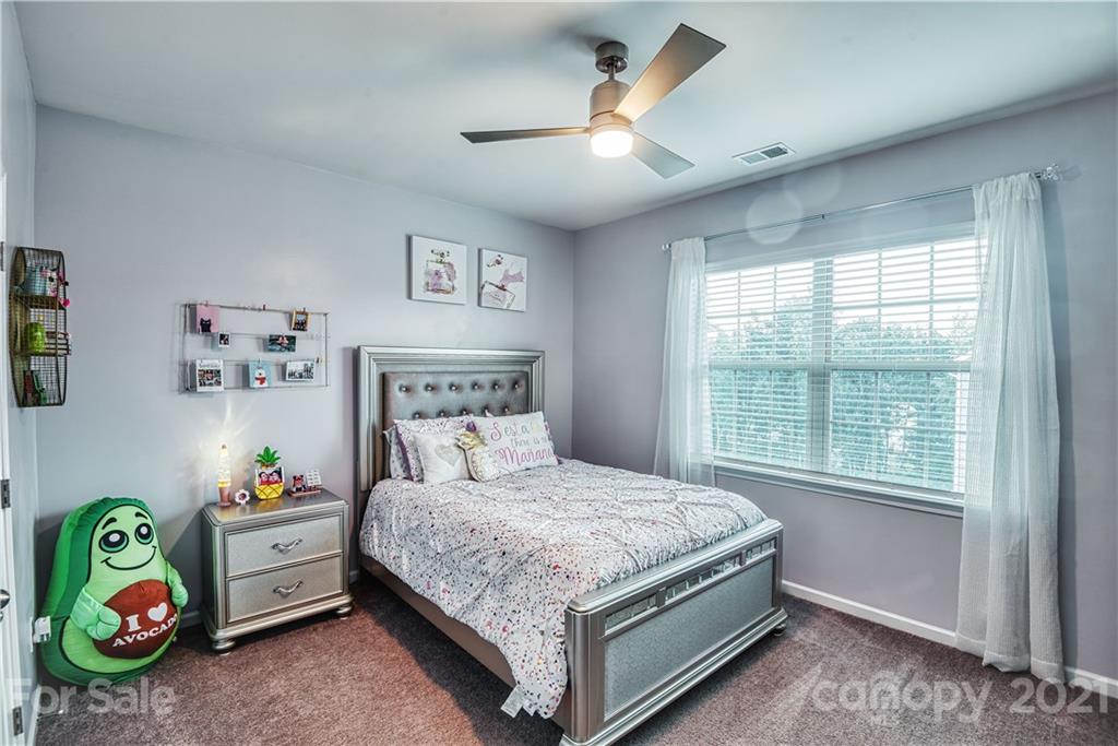 606 Amber Meadows Way Tega Cay, SC 29708 - Photo 16 of 23 a bedroom with a bed and a window