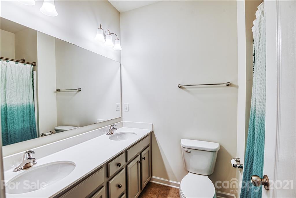 606 Amber Meadows Way Tega Cay, SC 29708 - Photo 18 of 23 a bathroom with a toilet sink and mirror
