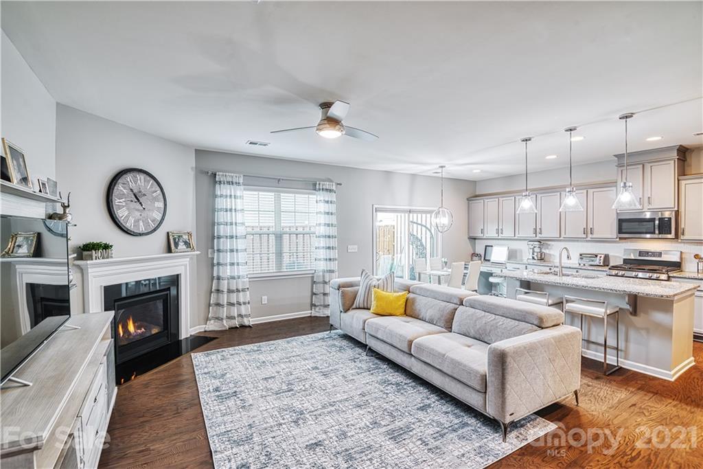 606 Amber Meadows Way Tega Cay, SC 29708 - Photo 6 of 23 a living room with furniture a fireplace and a television
