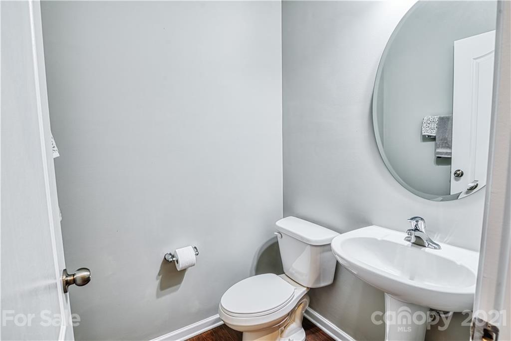 606 Amber Meadows Way Tega Cay, SC 29708 - Photo 8 of 23 a bathroom with a sink a toilet and a mirror