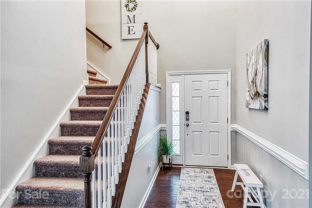 606 Amber Meadows Way Tega Cay, SC 29708 - Photo 10 of 23 a view of entryway with wooden floor and stairs