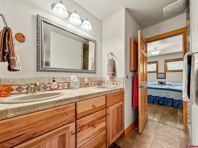 a bathroom with a granite countertop shower and a sink