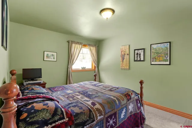 a bedroom with bed and a window