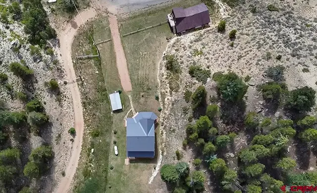 a view of a lush green hillside and a building