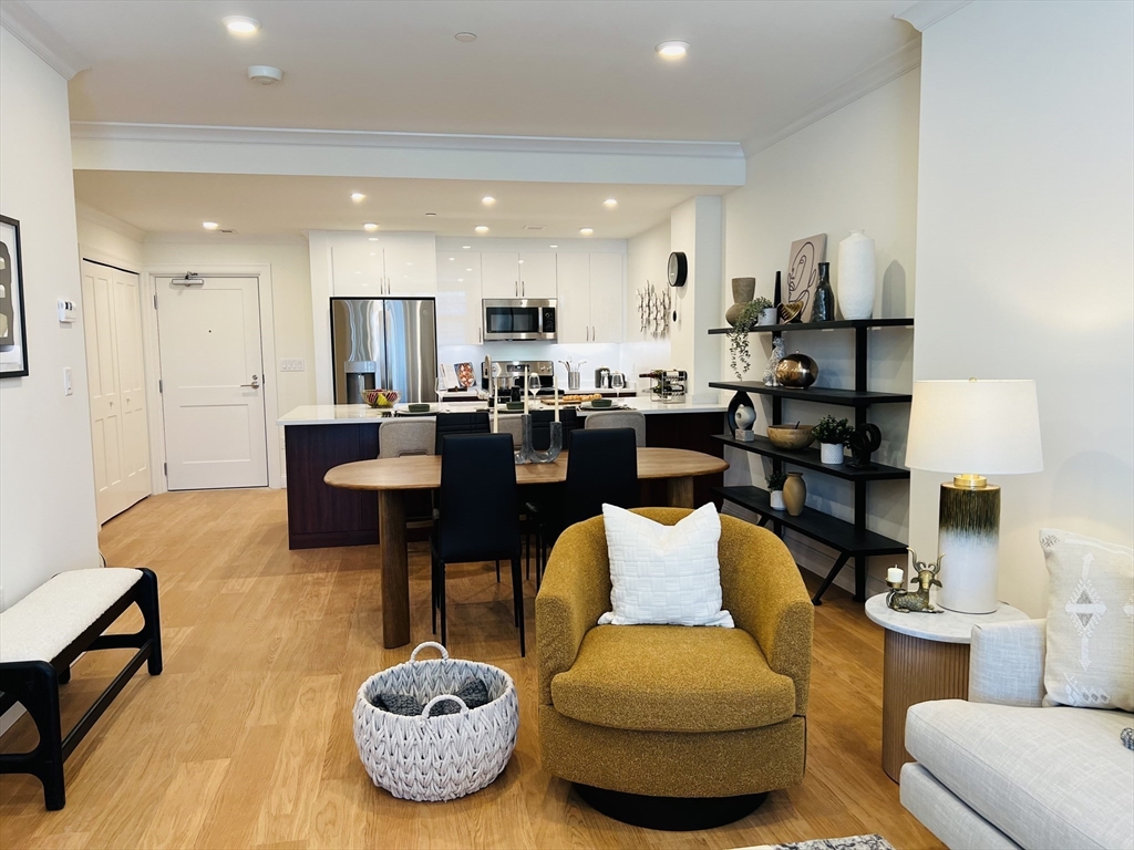 201 Sherman Road, Unit 838 Brookline, MA 02467 - Photo 20 of 25 a living room with furniture a rug and a chandelier