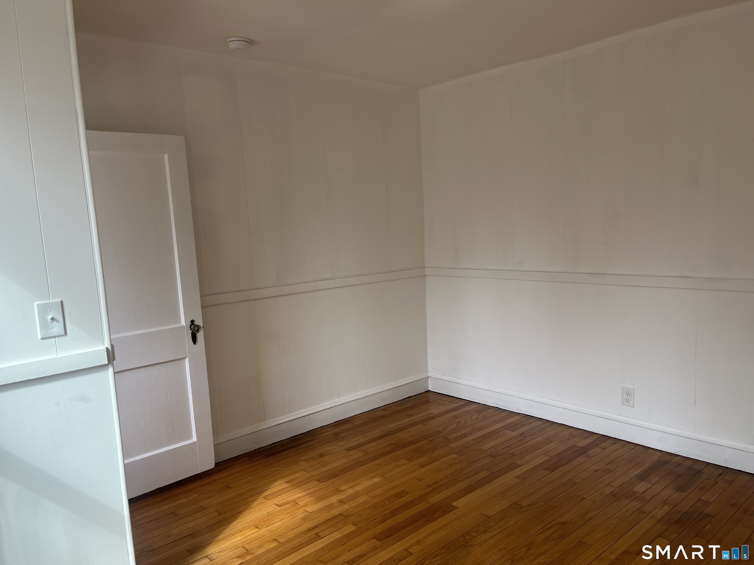 156 Union Street, Unit 2 Manchester, CT 06042 - Photo 14 of 16 an empty room with wooden floor