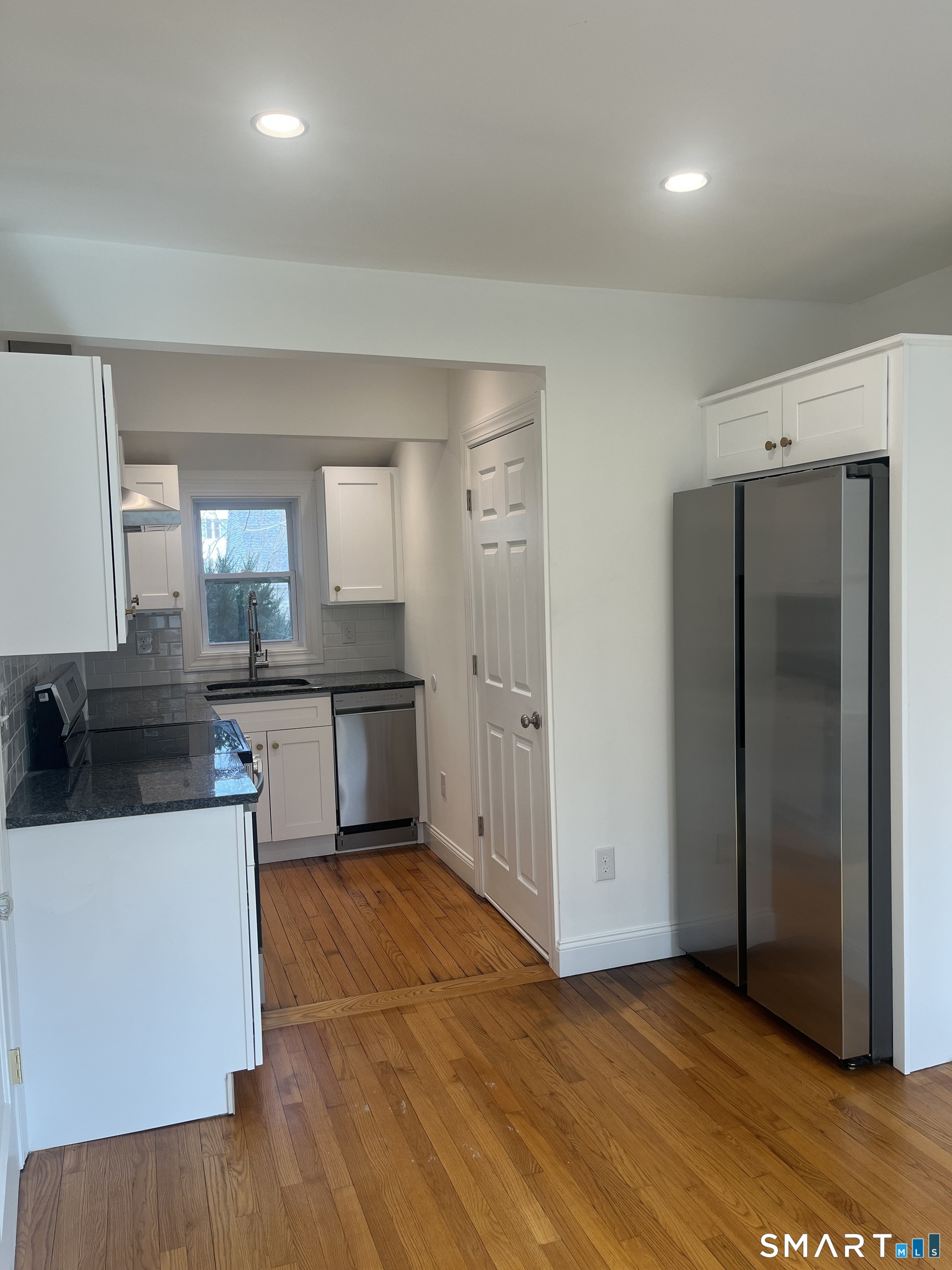 156 Union Street, Unit 2 Manchester, CT 06042 - Photo 2 of 16 a kitchen with stainless steel appliances a sink a stove a refrigerator and cabinets
