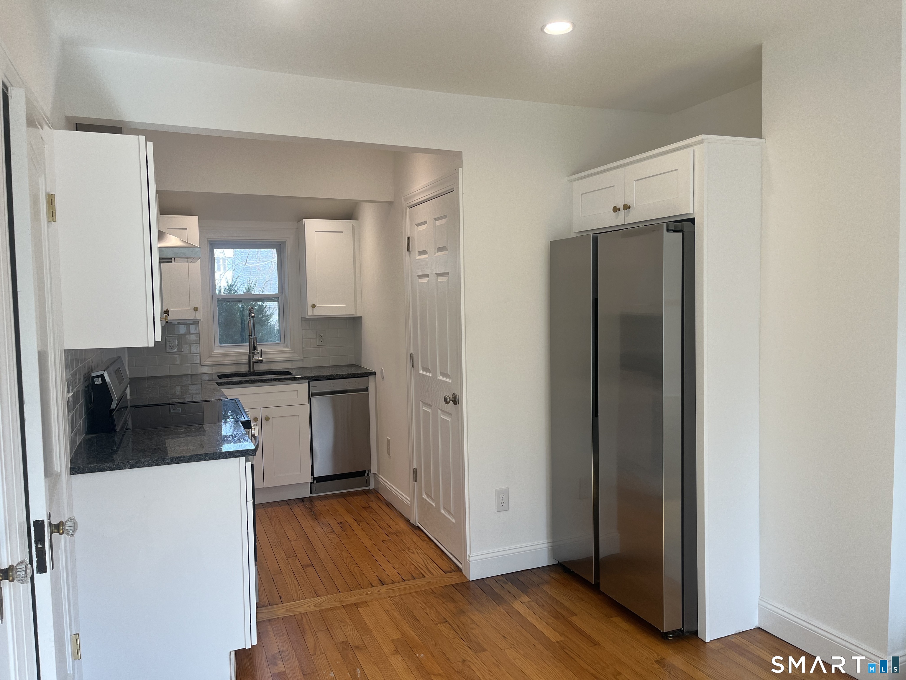 156 Union Street, Unit 2 Manchester, CT 06042 - Photo 3 of 16 a kitchen with refrigerator and cabinets
